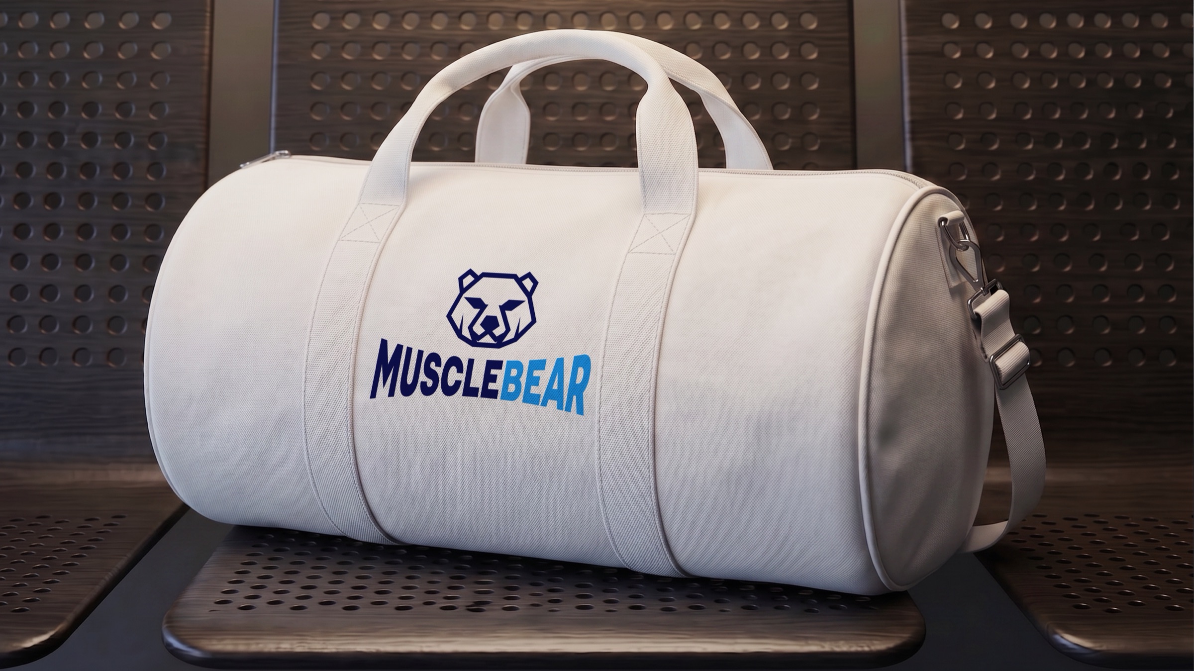 Een witte sporttas met het logo van MuscleBear op een bank